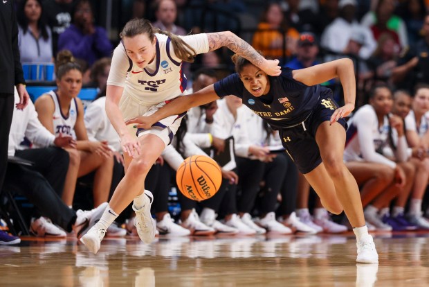 Notre Dame Fighting Irish guard Cassandre Prosper (8) battles TCU Horned Frogs guard Madison Conner (2) for a loose ball during the third quarter in the Sweet 16 of the NCAA college basketball tournament at Legacy Arena in Birmingham, Ala., on Saturday, March 29, 2025. (Eileen T. Meslar/Chicago Tribune)
