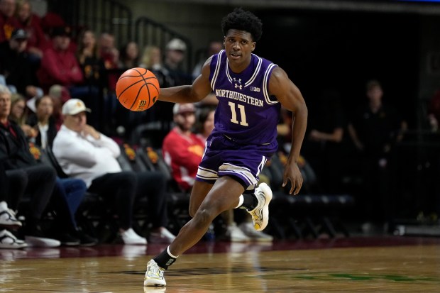 Northwestern guard Jordan Clayton drives up court during the first half against Iowa State on Oct. 26, 2025, in Ames, Iowa. (AP Photo/Charlie Neibergall)