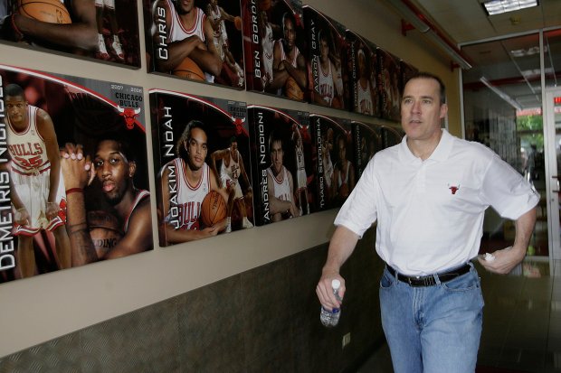 John Paxson, Executive Vice President of Basketball Operations walks pasts...