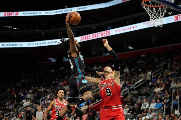 Pistons' Daniss Jenkins shoots against the Bulls center Nikola Vučević during the first half on Nov. 12, 2025, in Detroit. (AP Photo/Ryan Sun)