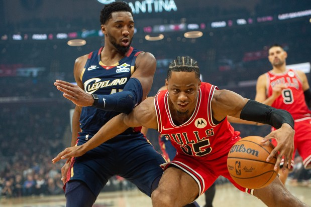 The Bulls' Isaac Okoro keeps the ball from Cavaliers guard Donovan Mitchell during the first half Saturday, Nov. 8, 2025, in Cleveland. (Phil Long/AP)