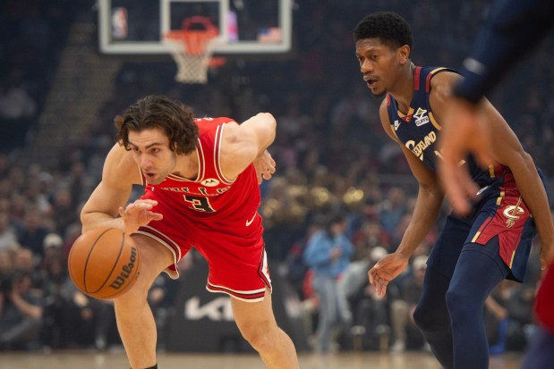 Bulls guard Josh Giddey, left, drives against Cavaliers forward De'Andre Hunter on Saturday, Nov. 8, 2025, in Cleveland. (Phil Long/AP)
