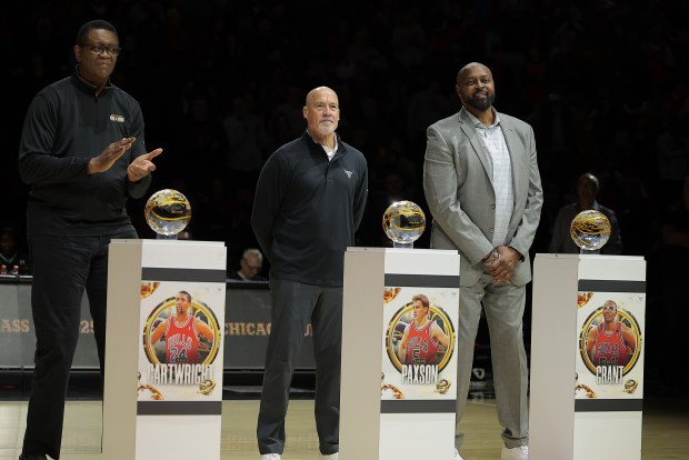 Bill Cartwright, from left, John Paxson and Horace Grant are inducted into the Bulls Ring of Honor during halftime of a game against the Wizards on Saturday, Nov. 22, 2025, at the United Center. (Melissa Tamez/AP)