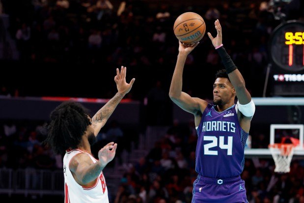Charlotte Hornets forward Brandon Miller (24) shoots over Chicago Bulls guard Coby White during the second half of an NBA Cup basketball game in Charlotte, N.C., Friday, Nov. 28, 2025. (AP Photo/Nell Redmond)