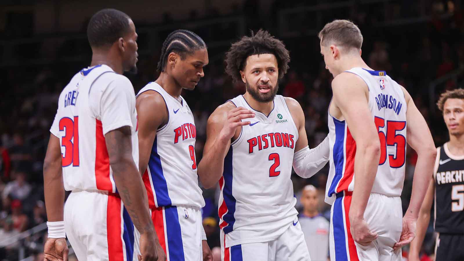 Detroit Pistons guard Javonte Green (31) and guard Ausar Thompson (9) and guard Cade Cunningham (2) and forward Duncan Robinson (55) against the Atlanta Hawks in the fourth quarter at State Farm Arena.
