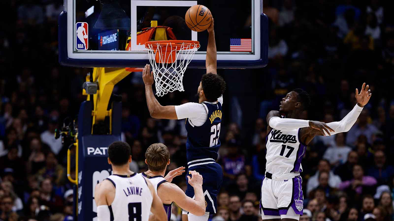 Denver Nuggets forward Cam Johnson (23) drives to the net against Sacramento Kings guard Dennis Schroder (17) as forward Domantas Sabonis (11) and guard Zach LaVine (8) defend in the fourth quarter at Ball Arena. 