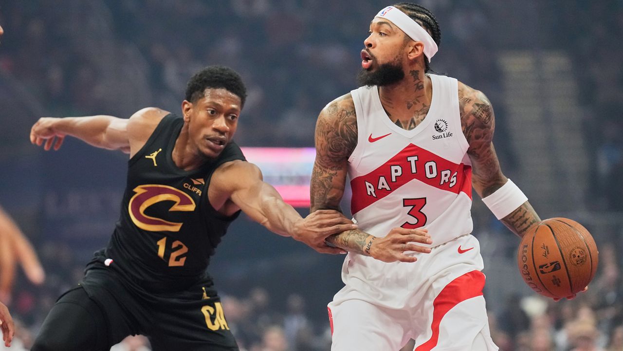 Cleveland Cavaliers' De'Andre Hunter (12) defends Toronto Raptors' Brandon Ingram (3) in the first half of an an NBA Cup basketball game in Cleveland, Friday, Oct. 31, 2025.