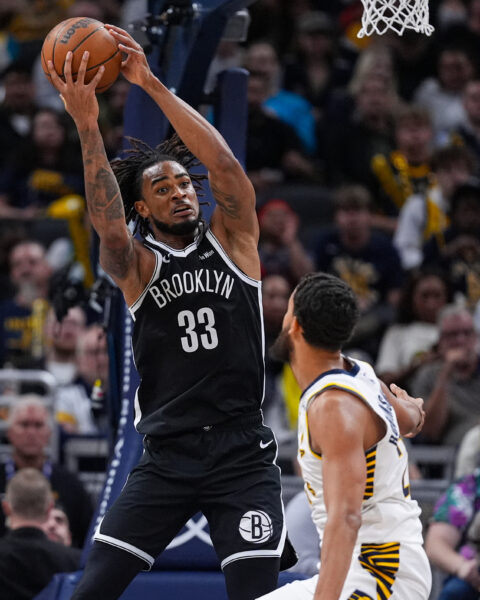 Brooklyn Nets center Nic Claxton (33) gets a rebound over Indiana Pacers forward Jeremiah Robinson-Earl (24) during the second half of an NBA basketball game in Indianapolis, Wednesday, Nov. 5, 2025. (AP Photo/Michael Conroy)