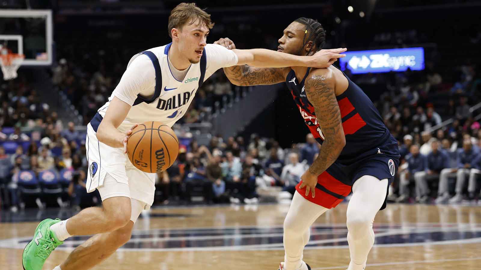 Dallas Mavericks forward Cooper Flagg (32) drives to the basket as Washington Wizards forward Cam Whitmore (1) defends in the first half at Capital One Arena. 