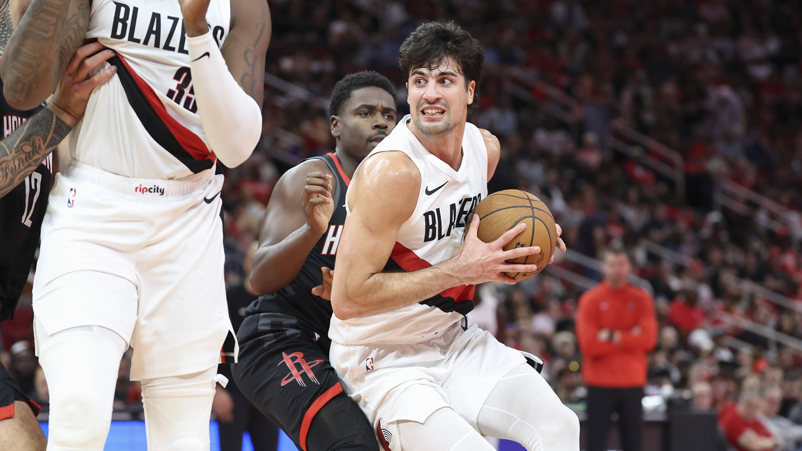 Portland Trail Blazers forward Deni Avdija (8) controls the ball as Houston Rockets guard Aaron Holiday (0) defends during the third quarter at Toyota Center. 