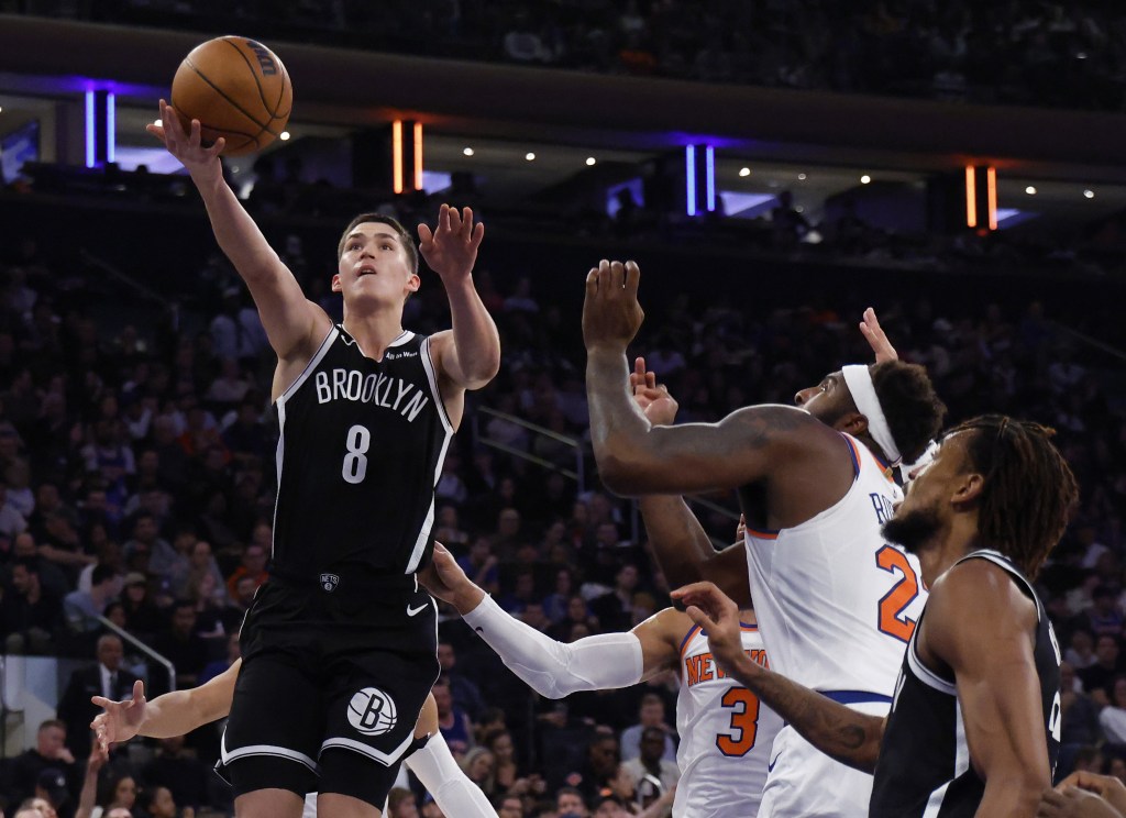 Egor Dëmin goes up for a layup as Mitchell Robinson defends during the Nets' blowout loss to the Knicks on Nov. 9, 2025.