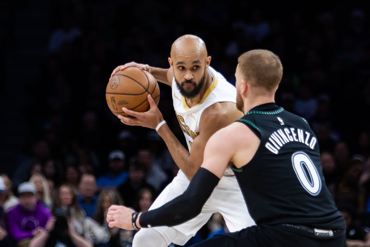 Minnesota Timberwolves' Donte DiVincenzo (0) defends against Boston Celtics' Derrick White (9) during the second half of an NBA basketball game, Saturday, Nov. 29, 2025, in Minneapolis. (AP Photo/Lily Dozier)