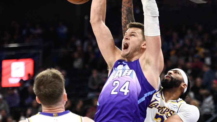 Walker Kessler #24 of the Utah Jazz dunks over Anthony Davis #3 of the Los Angeles Lakers...