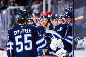 WINNIPEG, CANADA - OCTOBER 30: Mark Scheifele #55 of the Winnipeg Jets celebrates a second period goal against the Chicago Blackhawks with teammates at the bench at the Canada Life Centre on October 30, 2025 in Winnipeg, Manitoba, Canada. (Photo by Darcy Finley/NHLI via Getty Images)