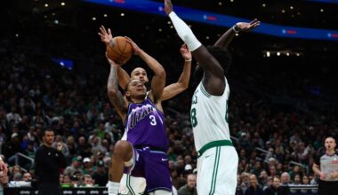 Keyonte George #3 of the Utah Jazz tries to get off a shot over Neemias Queta #88 of the Boston Cel...