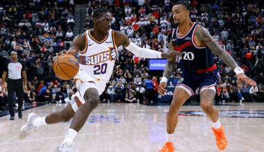 Rasheer Fleming #20 of the Phoenix Suns drives to the basket on John Collins #20 of the LA Clippers...