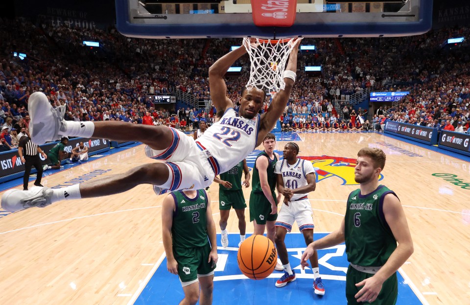 Guard Darryn Peterson #22 of the Kansas Jayhawks dunks during the first half of the game against the Green Bay Phoenix at Allen Fieldhouse