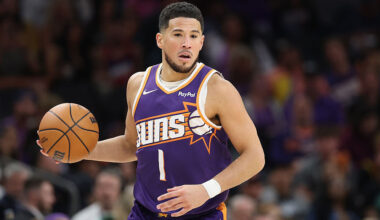 Devin Booker #1 of the Phoenix Suns handles the ball during the NBA game at Mortgage Matchup Center...