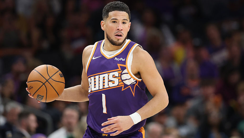Devin Booker #1 of the Phoenix Suns handles the ball during the NBA game at Mortgage Matchup Center...