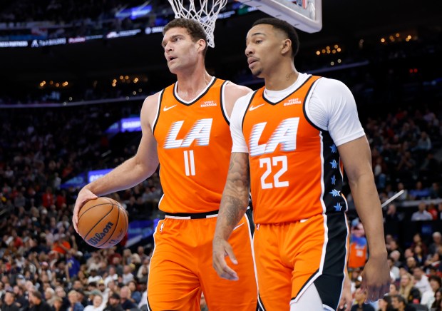 The Clippers’ Brook Lopez, left, and Jordan Miller react as...