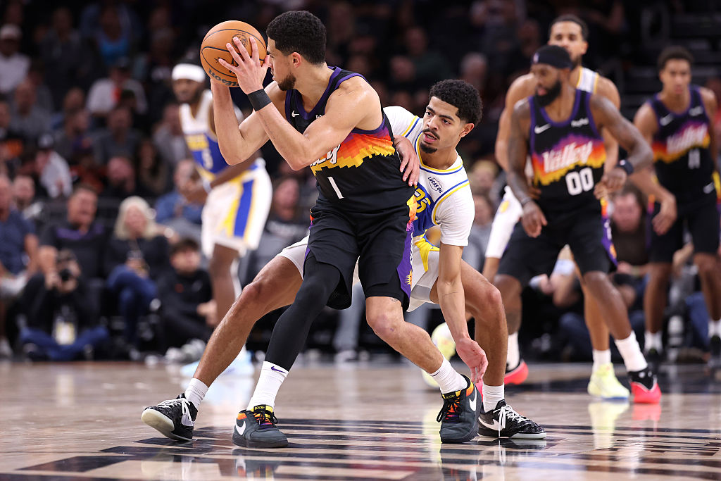 PHOENIX, ARIZONA - NOVEMBER 13: Ben Sheppard #26 of the Indiana Pacers pressures Devin Booker #1 of the Phoenix Suns during the second half at Mortgage Matchup Center on November 13, 2025 in Phoenix, Arizona. NOTE TO USER: User expressly acknowledges and agrees that, by downloading and or using this photograph, User is consenting to the terms and conditions of the Getty Images License Agreement. (Photo by Chris Coduto/Getty Images)