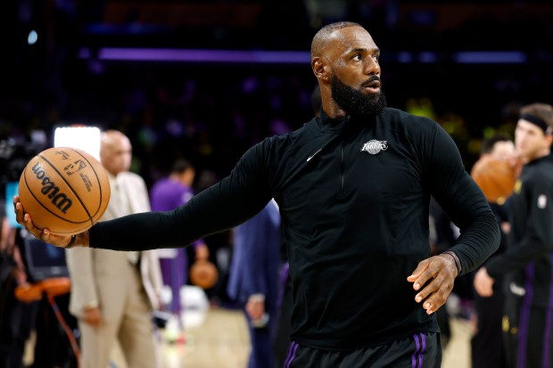Lakers star LeBron James warms up before their game against...
