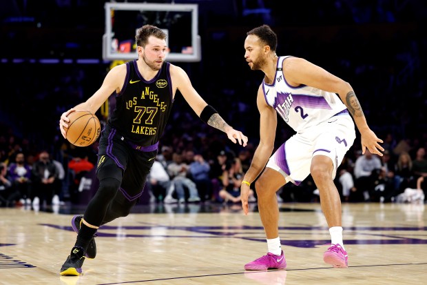 Lakers star Luka Doncic handles the ball as the Utah...