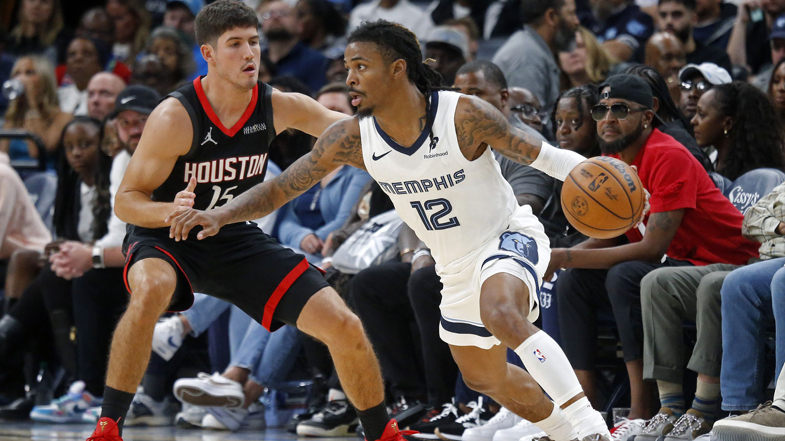 Grizzlies guard Ja Morant (12) dribbles as Houston Rockets guard Reed Sheppard (15) defends during the fourth quarter at FedExForum
