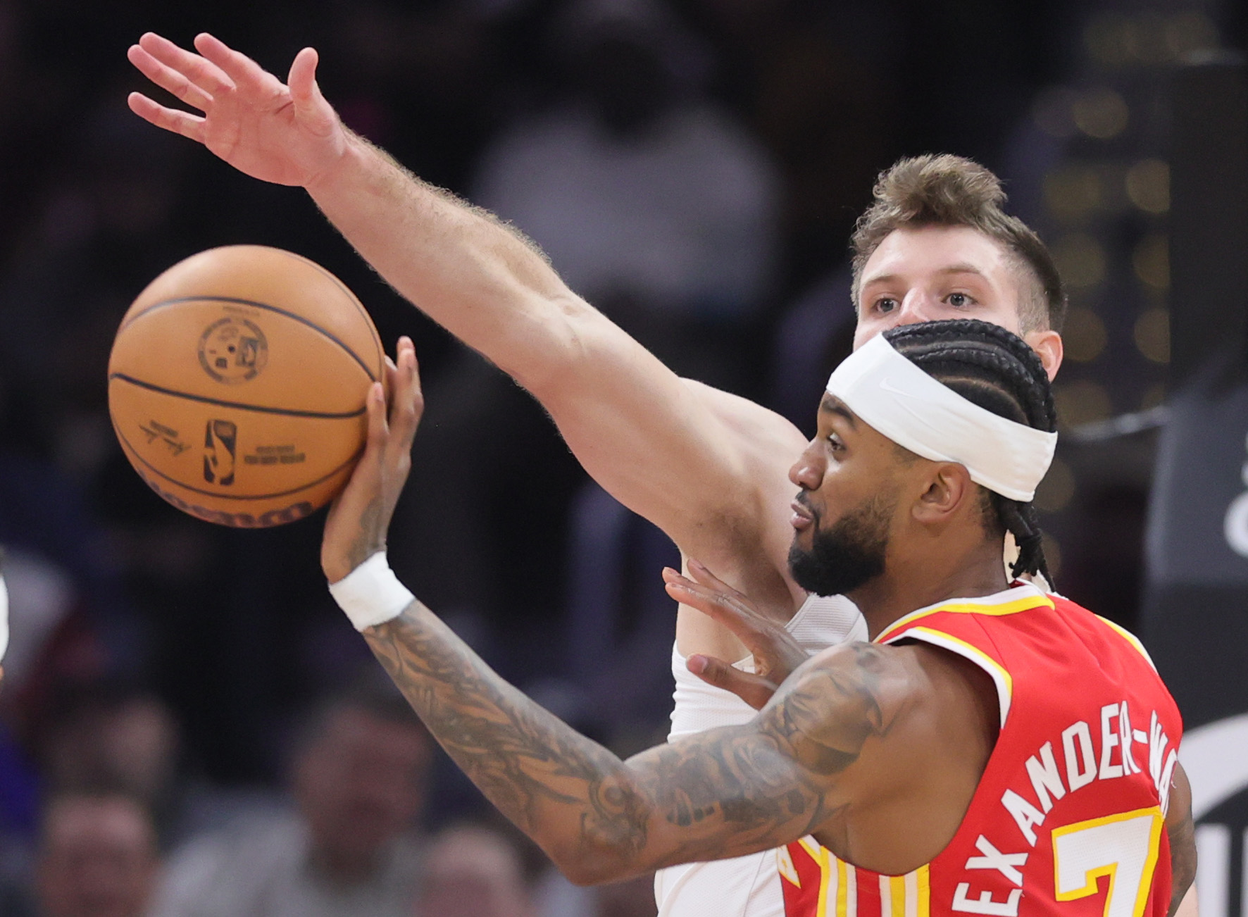 Atlanta Hawks guard Nickeil Alexander-Walker passes the basketball guarded by Cleveland Cavaliers forward Dean Wade in the first half at Rocket Arena. 