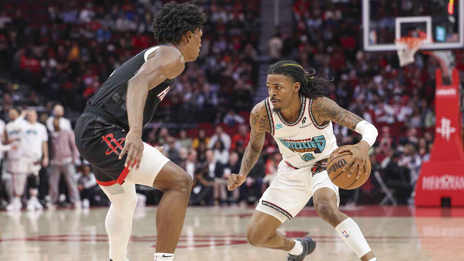 Memphis Grizzlies guard Ja Morant (12) dribbles the ball as Houston Rockets forward Amen Thompson (1) defends during the first quarter at Toyota Center.