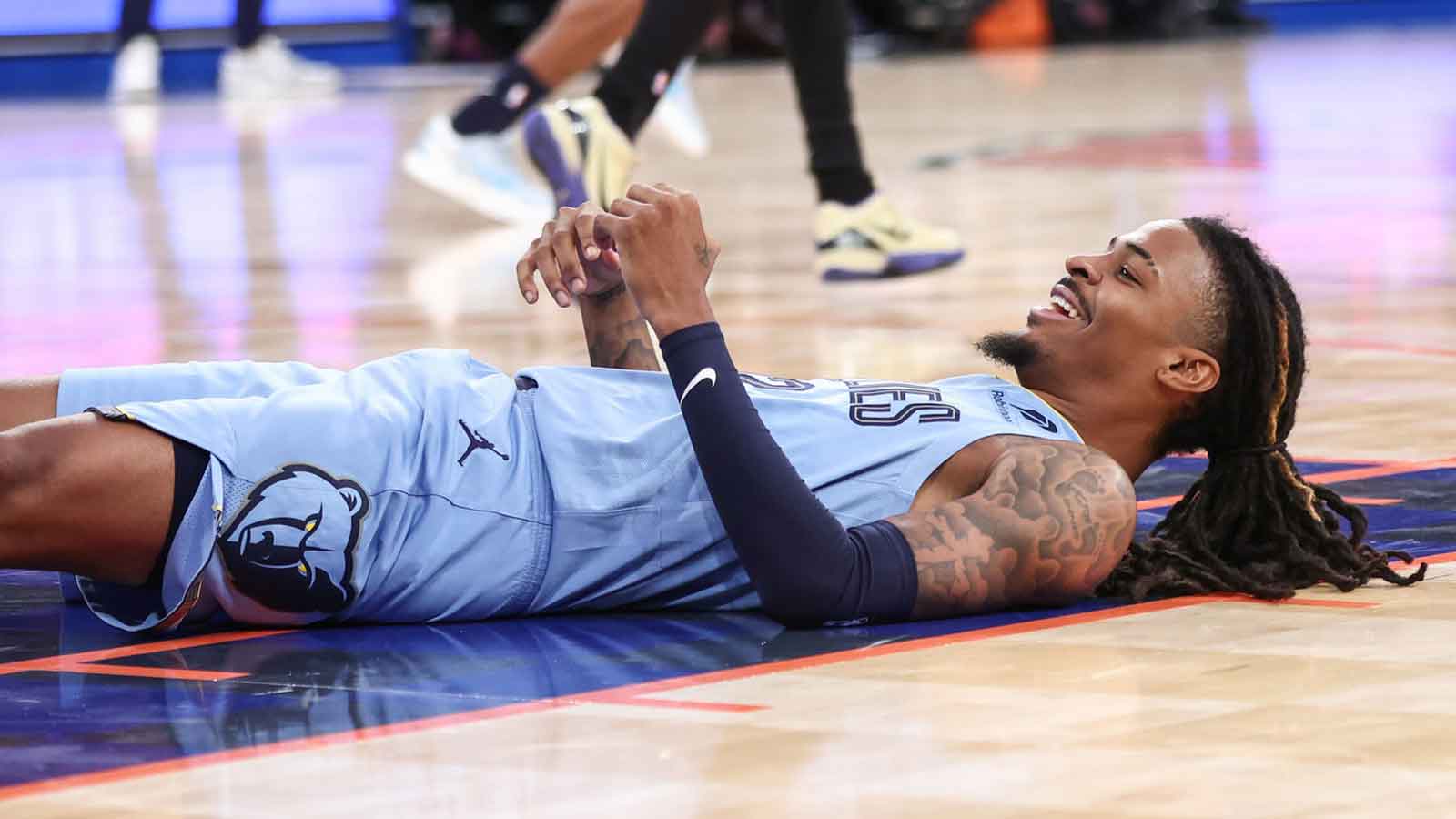 Memphis Grizzlies guard Ja Morant (12) lays on the court after attempting to score in the third quarter against the New York Knicks at Madison Square Garden. 