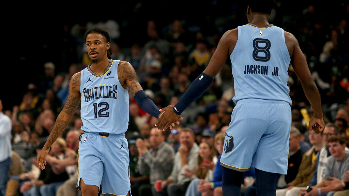 Memphis Grizzlies guard Ja Morant (12) reacts with forward/center Jaren Jackson Jr. (8) during the first quarter against the Los Angeles Lakers at FedExForum. 