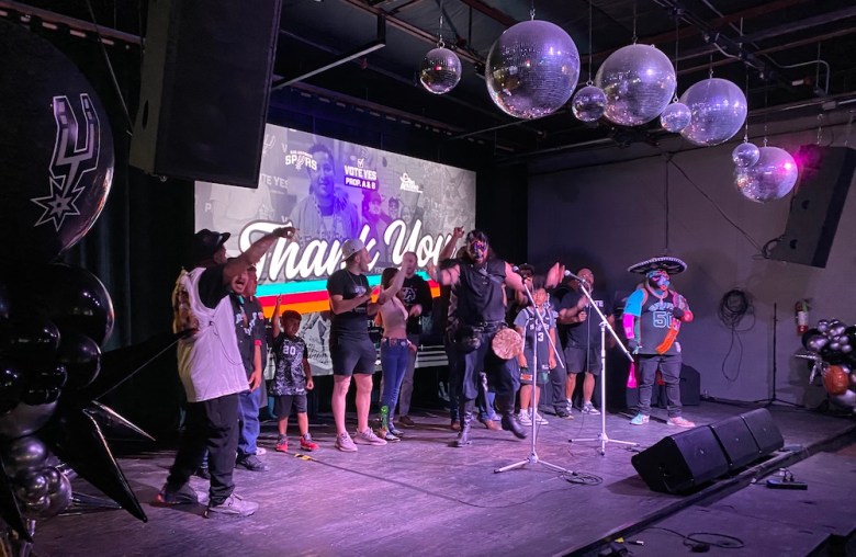 Spurs super-fans the Jackals cheer onstage at the team's watch party.