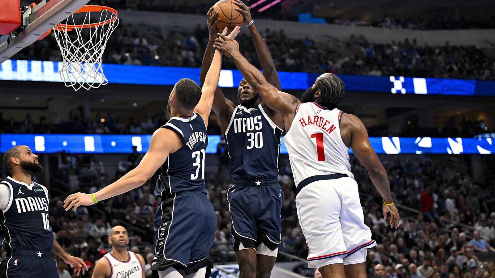 Dallas Mavericks center Moussa Cisse (30) grabs a rebound in front of LA Clippers guard James Harden (1) and guard Klay Thompson (31) during the second quarter in an NBA Cup game at the American Airlines Center.