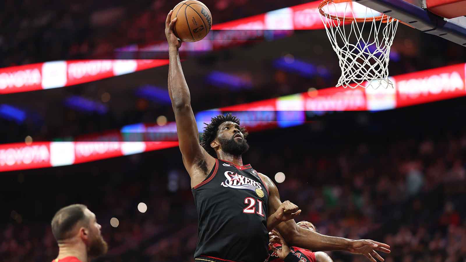 Philadelphia 76ers center Joel Embiid (21) drives for a shot against Toronto Raptors forward Scottie Barnes (4) during the second quarter at Xfinity Mobile Arena. 