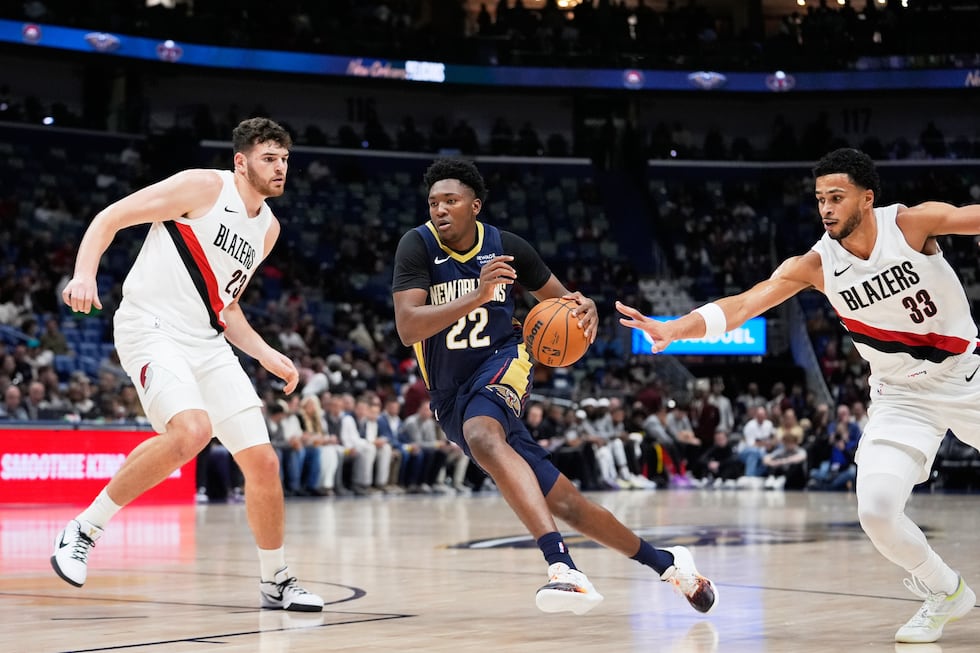 New Orleans Pelicans center Derik Queen (22) drives to the basket between Portland Trail...