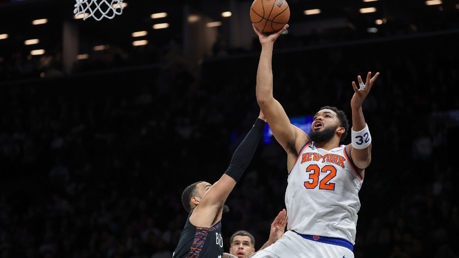 New York Knicks center Karl-Anthony Towns (32) shoots the ball as Brooklyn Nets guard Tyrese Martin (13) defends during the first half at Barclays Center.