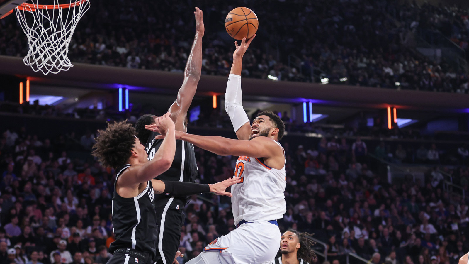 New York Knicks center Karl-Anthony Towns (32) shoots over Brooklyn Nets center Day'Ron Sharpe (20) and forward Jalen Wilson (22) in the second quarter at Madison Square Garden.