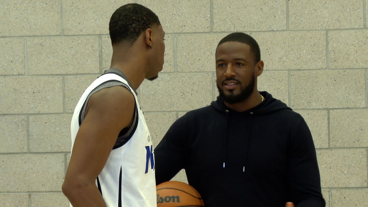 Osceola Magic GM Kevin Tiller (right) talks with Magic two-way player Jamal Cain after practice. (Brandon Green/Spectrum Sports 360)