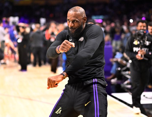 Lakers star LeBron James gestures during warmups before their game...