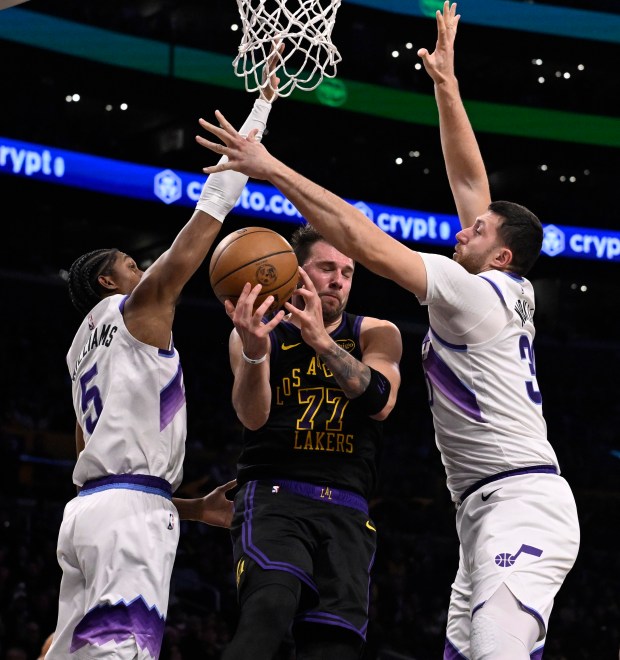 Lakers star Luka Doncic loses the ball as he drives...