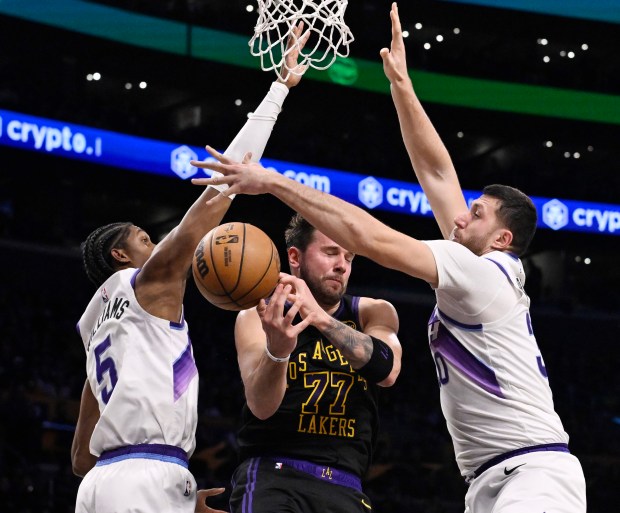 Lakers star Luka Doncic loses the ball as he drives...