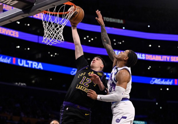 Lakers forward Jake LaRavia dunks in front of the Utah...