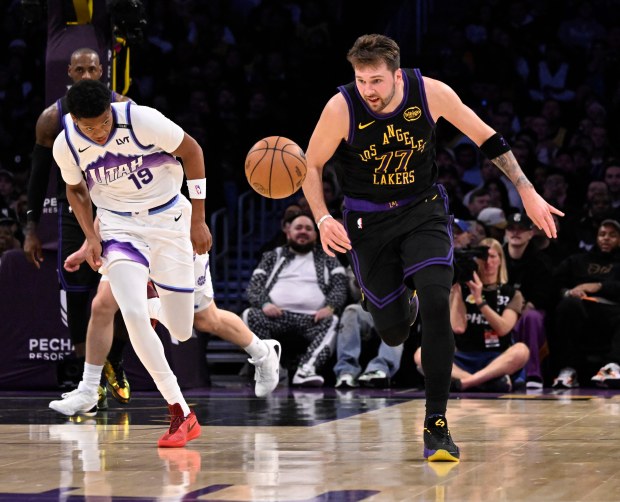 Lakers star Luka Doncic, right, steals the ball from Utah...