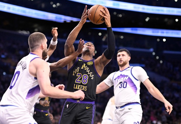 Lakers forward Rui Hachimura drives to the basket as the...