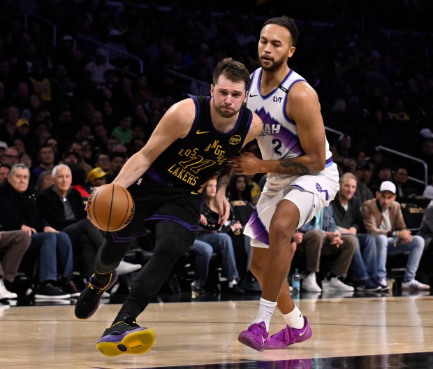 Lakers star Luka Doncic drives to the basket as the...