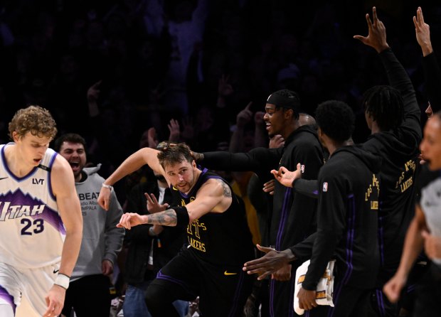 Lakers star Luka Doncic (77) reacts after making a 3-point...