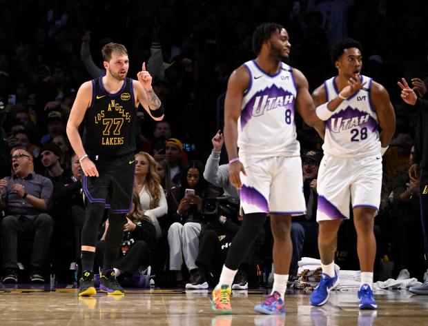 Lakers star Luka Doncic (77) reacts after making a 3-point...