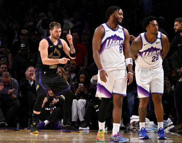Lakers star Luka Doncic (77) reacts after making a 3-point...