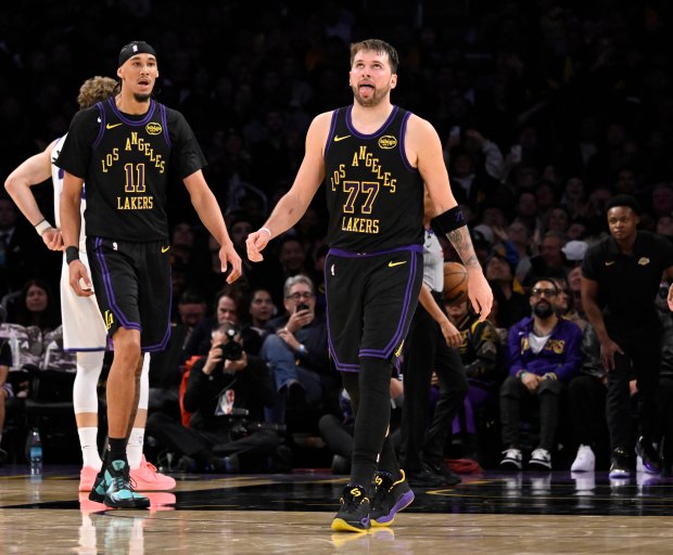 Lakers star Luka Doncic (77) reacts after making a 3-point...